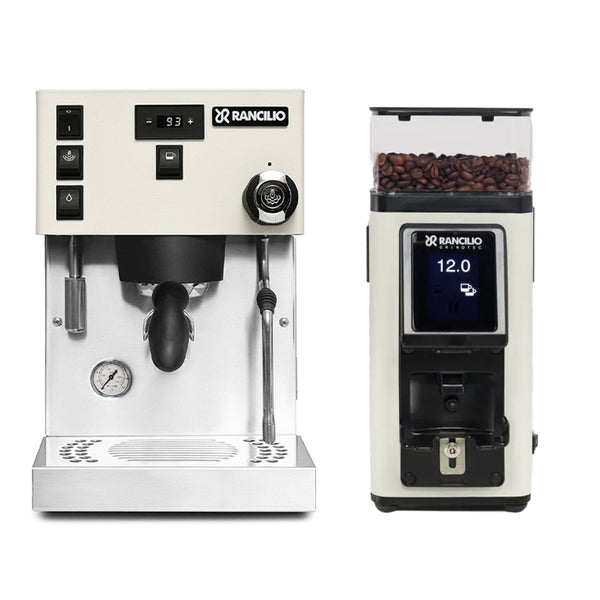 The Rancilio Silvia Pro X Dual Boiler and Rancilio Stile Grinder Bundle (White) offers the perfect combination for coffee lovers. The Silvia Pro X features digital controls, a portafilter, steam wand, and pressure gauge. The Rancilio Stile Grinder boasts a digital display and a bean hopper filled with coffee beans. Both are made of stainless steel.