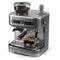 A silver Philips Barista Brew Semi Automatic Espresso Machine PSA3218/01 with a built-in grinder featuring a dual bean container filled with coffee beans. Two espresso shots are being poured into small glass cups on the tray. Various buttons, a steam wand, and a stainless steel portafilter are visible on the front of the machine.