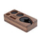 **Normcore Narrow Espresso Tamping Station - Walnut** by **Normcore** is a wooden dock organizer featuring multiple compartments, expertly designed to securely hold your phone, watch, and other small items. The phone slot is carved to accommodate a device with a cover, ensuring stable placement. Styled similarly to professional barista tools, its elegant finish showcases the natural walnut wood grain for both a stylish and practical solution.