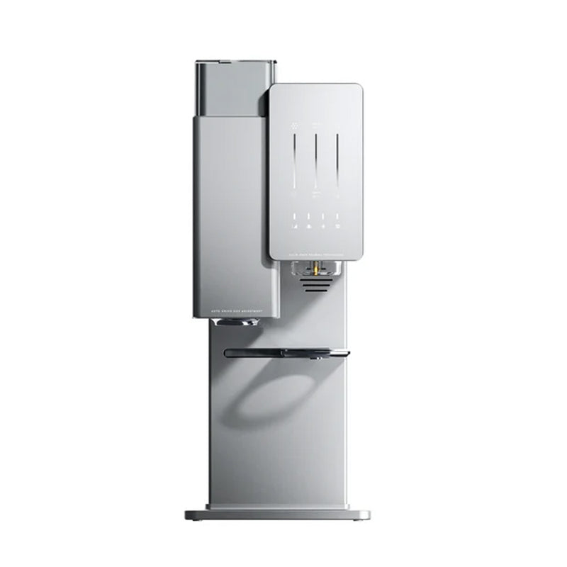 A sleek, modern countertop water dispenser is displayed against a white background. The unit features a silver rectangular design with dispensers for cold, hot, and ambient water. It includes a small digital display and a bottom drip tray, offering precision akin to the xBloom Original Automatic Bean-to-Cup Smart Coffee Maker with Built-in Grinder (Cloud Silver) by xBloom.