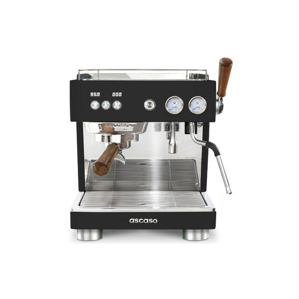 The Ascaso Baby T Plus Espresso Machine BT203U (Black) by Ascaso features a sleek shiny metal front, dual pressure gauges, and wooden handles on the portafilter and steam wand. This professional espresso machine also includes a drip tray at the bottom and a control panel with buttons and a digital display.