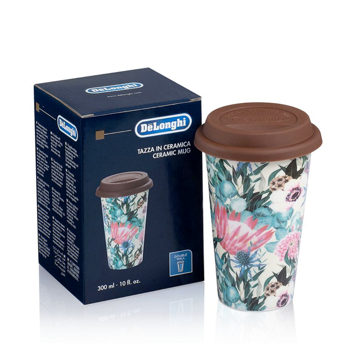 A DeLonghi Double Walled Ceramic Thermal Mug (Multi-coloured Flower) DLSC065, featuring thermal insulating properties and a brown silicone lid, is positioned next to its packaging box. The blue box displays the brand name "DeLonghi" along with product details. The mug has a capacity of 300 ml (10 fl oz).