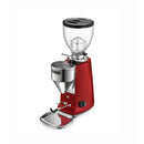 The Mazzer Mini Type A V2 Electronic Grinder (Red) features a transparent bean hopper on top, a silver grind adjustment dial in the center, and a portafilter holder at the bottom. This commercial-grade grinder from Mazzer boasts 64mm flat burrs, a rectangular black on/off switch on the body, and a small drip tray beneath.