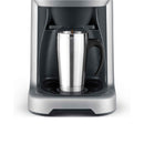 The Breville Grind Control™ Stainless Steel Thermal Coffee Maker BDC650BSS, with its sleek, modern design and brushed metal finish, brews directly into a silver travel mug with a black handle. It features Steep and Release technology to ensure the perfect brew every time.