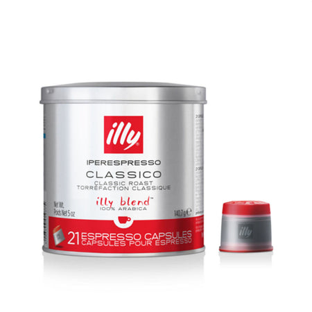 A silver tin with a red lid labeled "Illy Iperespresso Classico Medium Espresso Capsules" contains 21 ethically sourced coffee capsules compatible with Illy Iperespresso Brewers. One capsule is displayed in front of the tin, showcasing its grey body and red top. The tin also mentions "100% Arabica" and "illy blend.